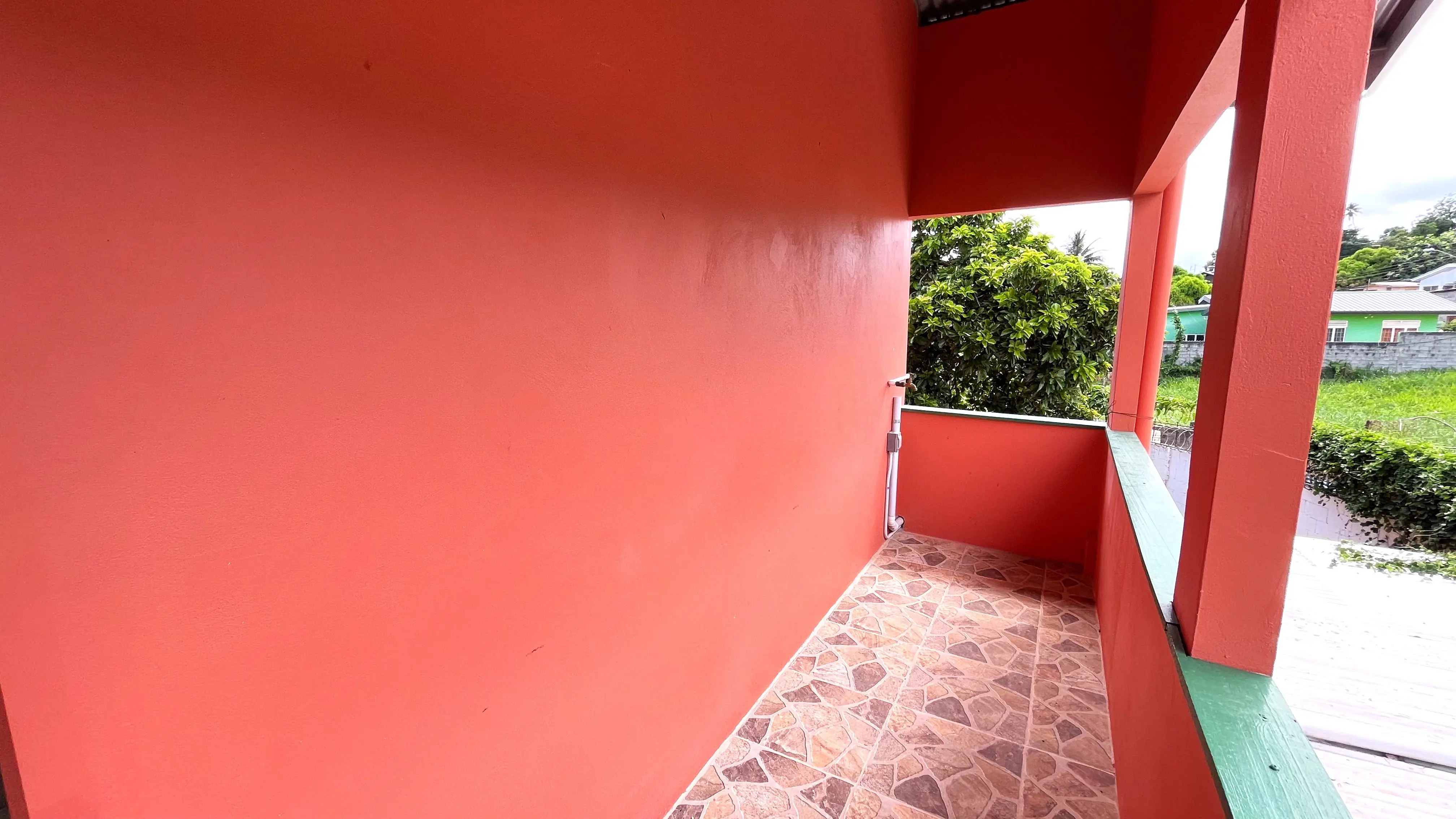 Covered upstairs balcony at two-bedroom apartment for rent in Champs Fleurs