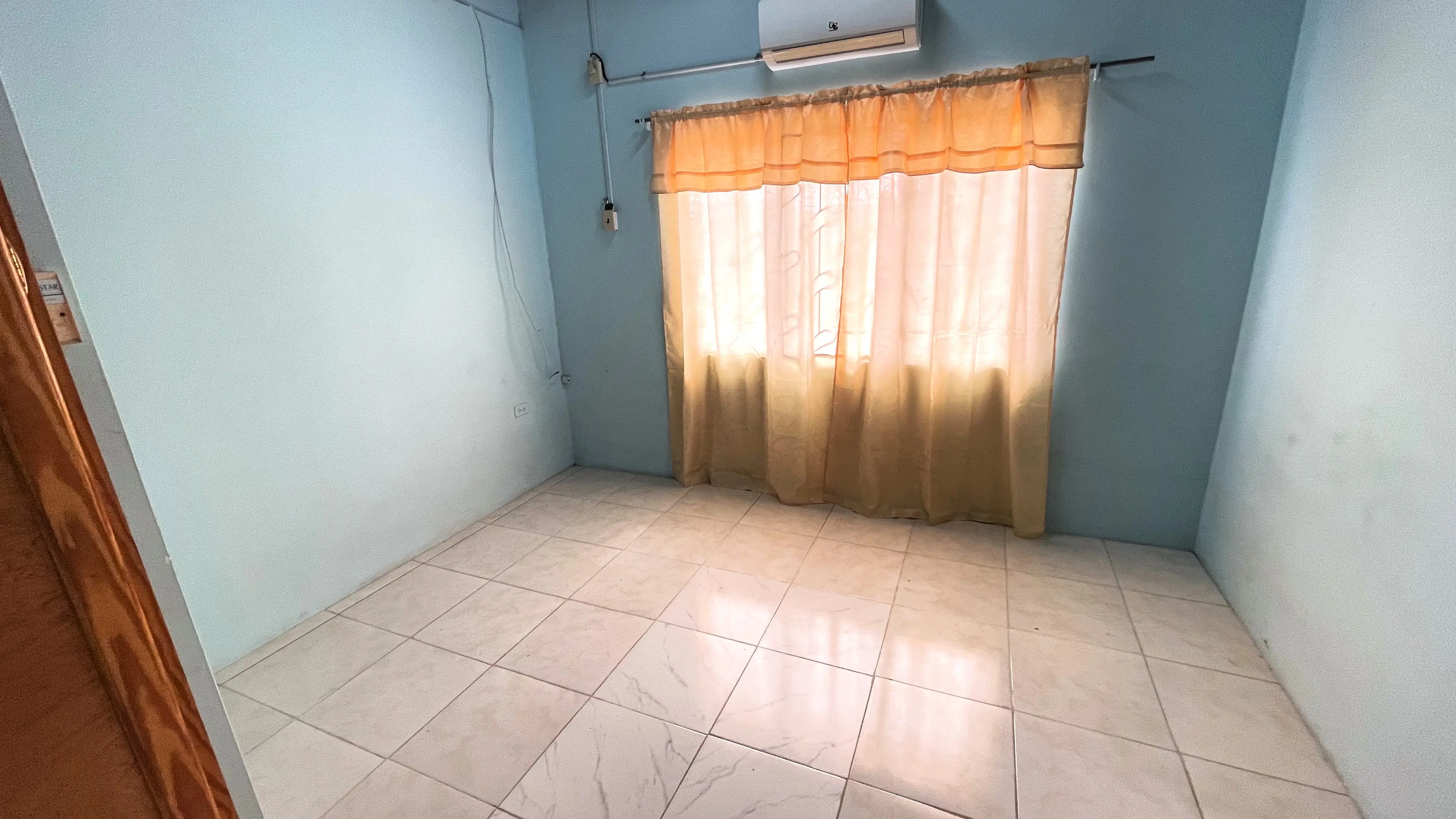 Air-conditioned bedroom with tiled floors in two-bedroom Champs Fleurs apartment