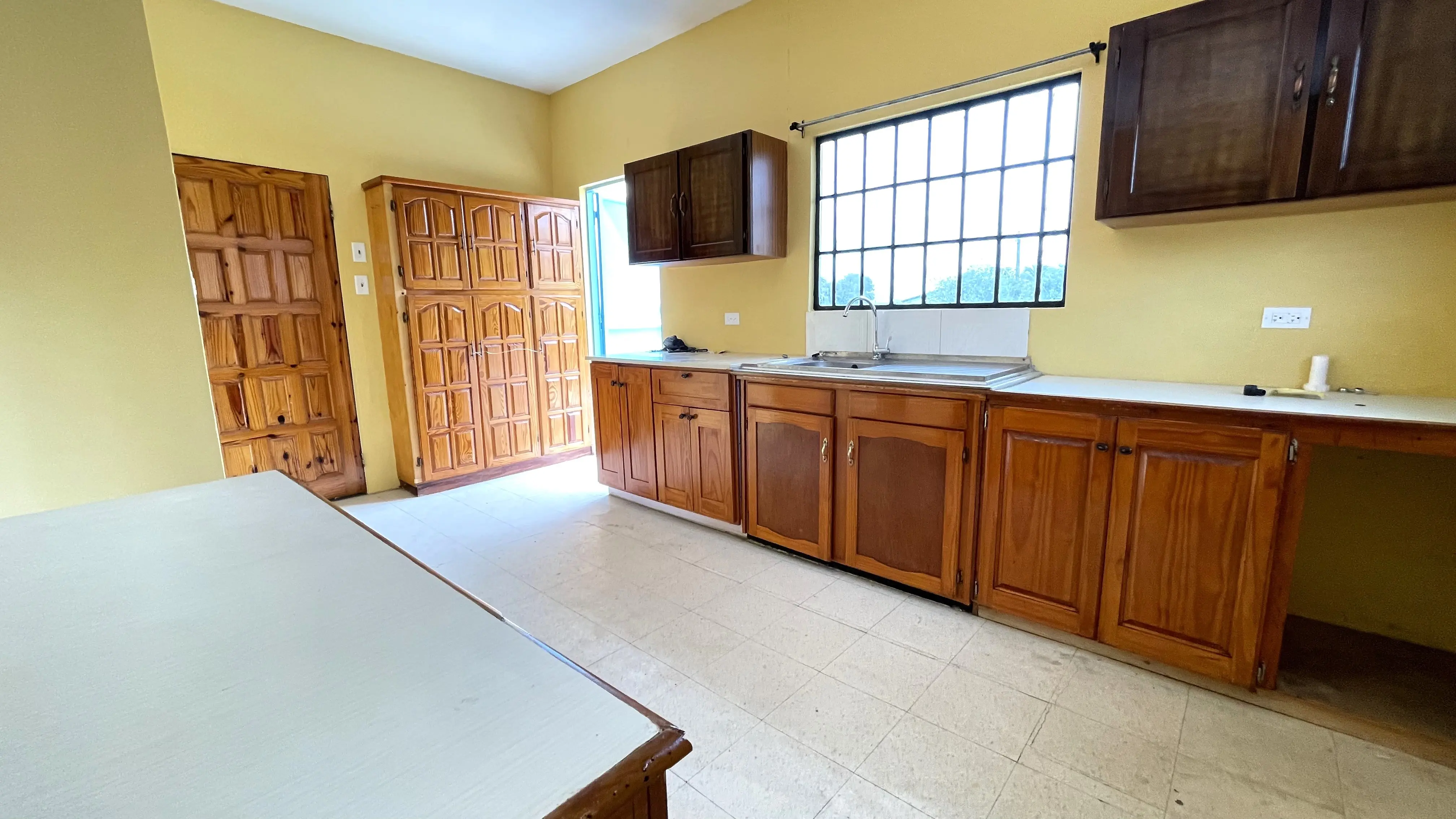 tacarigua-2-bedroom-apartment-kitchen-enterance-with cupboards